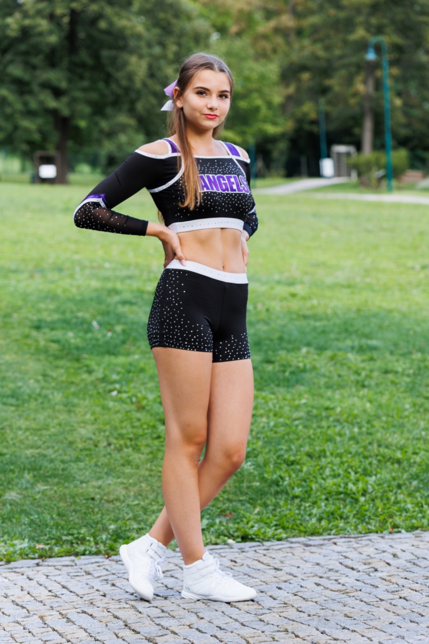 Black Angels uniform with white and purple details and a mesh on the sleeves. Clear rhinestones complement this beautiful design.